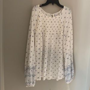 White blouse with blue detailing.